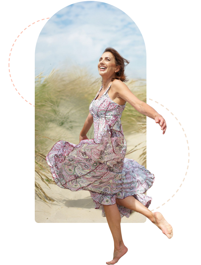 A young woman dancing on the beach
