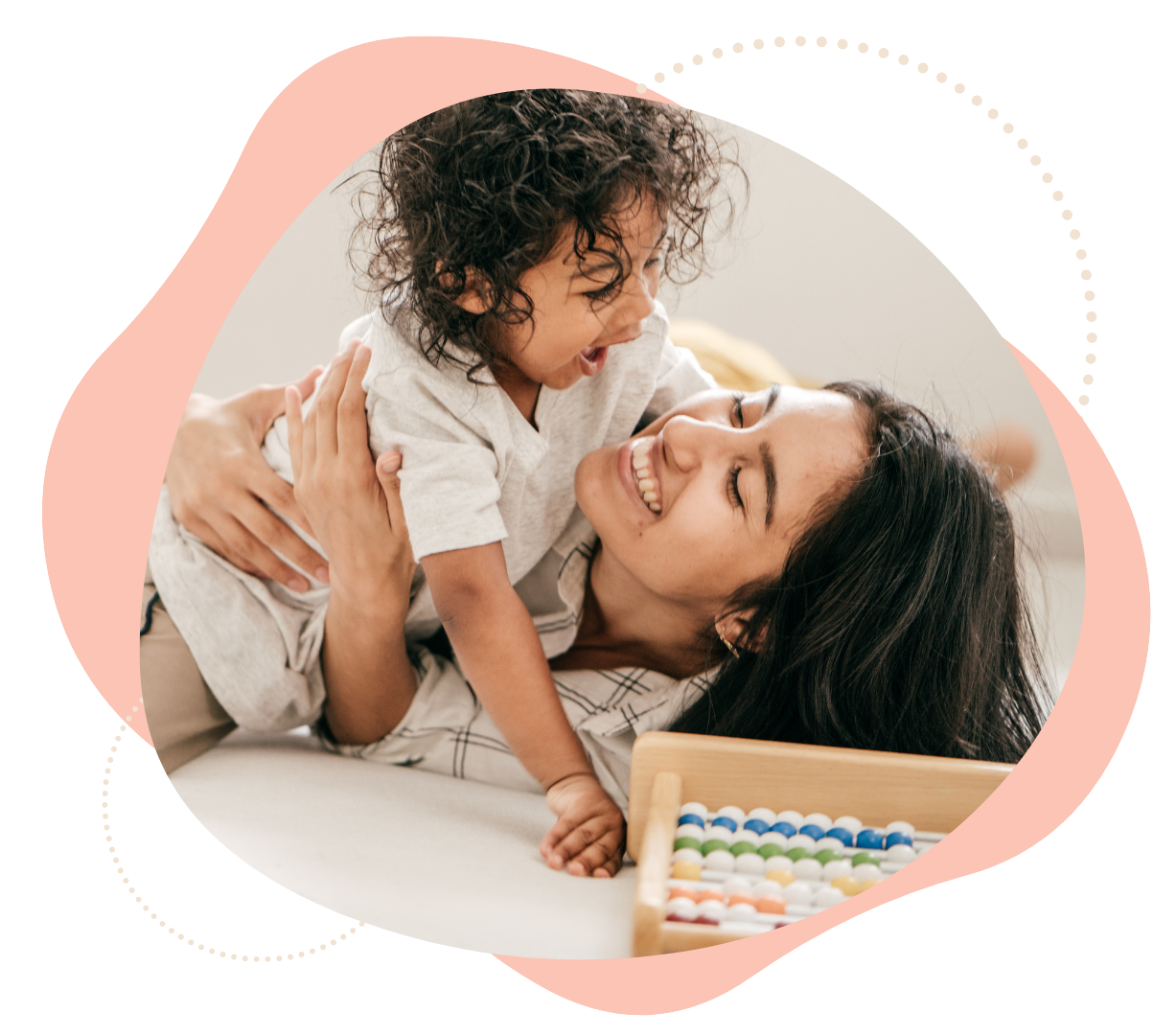 A mom playing with her laughing baby